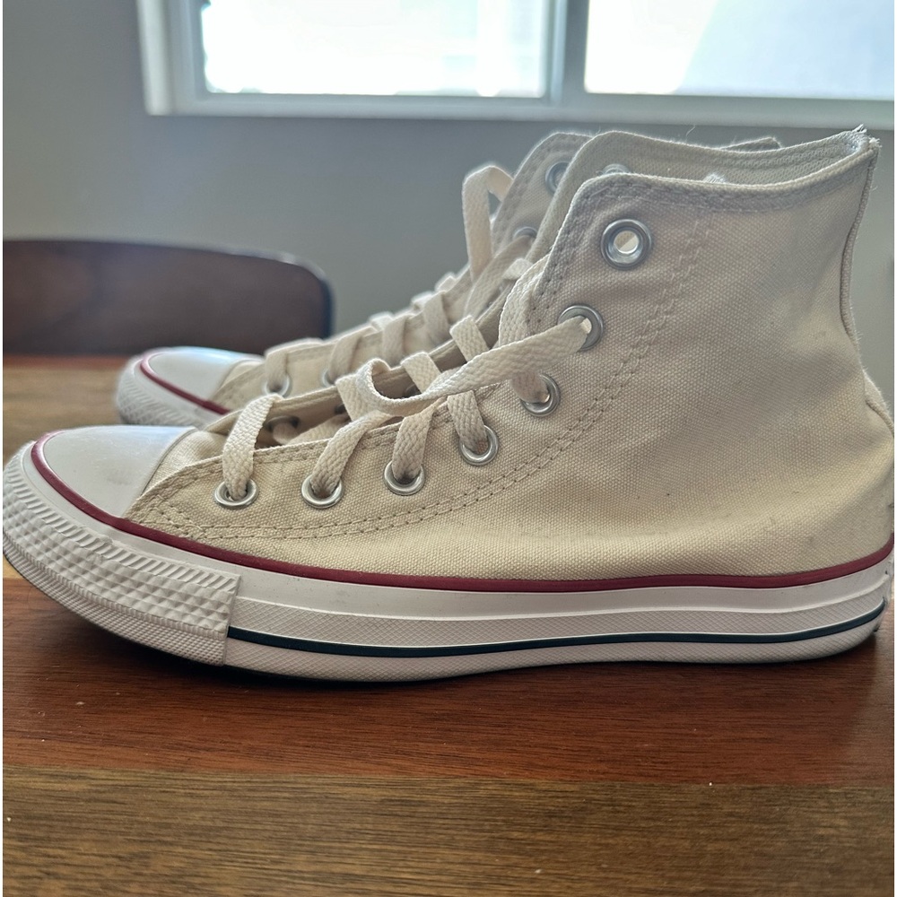Cream colored hightop Converse All Stars.
